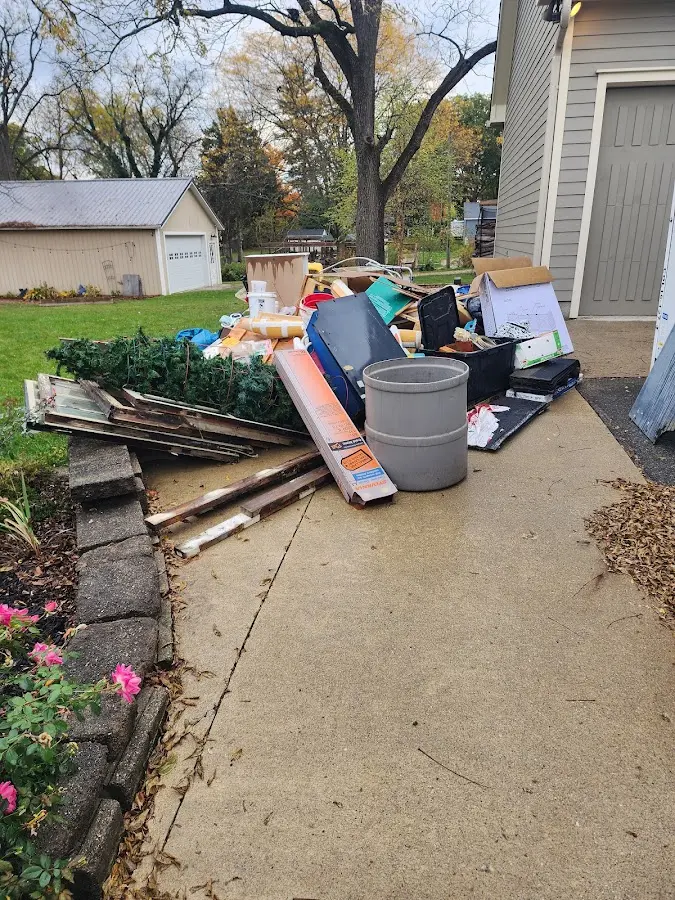 Dumpster being loaded with debris for Commercial Dumpster Rental in North Branford